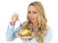 Young Blonde Haired Woman Eating a Baked Potato with Cheese