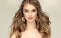 Beautiful model with long, dense, freely laying hairstyle and neat makeup.