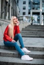 Young blonde hipster woman Smiling blonde woman laughing on the street cheerfully. Lovely young lady feeling happy Royalty Free Stock Photo