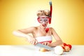 Young blonde housewife chopping onion in diving mask Royalty Free Stock Photo