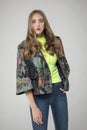 Young blonde model posing in a stylish flower pattern jacket Royalty Free Stock Photo