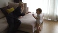 Young blonde mother having quality time with her baby boy son at family home flat - Wearing black budoir dress costume