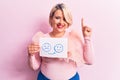 Young blonde plus size woman asking for positive change holding paper with emotion message smiling with an idea or question