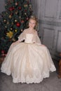 Blonde princess in white elegant christmas dress