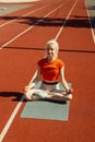 Young blonde relaxes on a sports mat