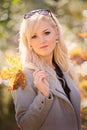 A young, blonde and smiling woman portrait on a sunny autumn day Royalty Free Stock Photo