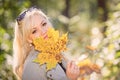 A young, blonde and smiling woman portrait on a sunny autumn day Royalty Free Stock Photo