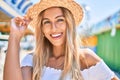 Young blonde tourist girl smiling happy looking to the camera at fairground