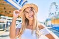 Young blonde tourist girl smiling happy looking to the side at fairground