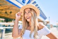 Young blonde tourist girl smiling happy looking to the side at fairground