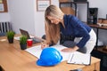 Young blonde woman architect drawing house plans at office Royalty Free Stock Photo