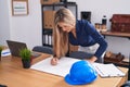 Young blonde woman architect drawing house plans at office Royalty Free Stock Photo