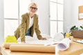 Young blonde woman architect looking house plans smiling at office Royalty Free Stock Photo