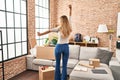 Young blonde woman on back view dancing at new home Royalty Free Stock Photo