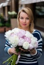Young blonde woman in blue dress with peonies bouquet Royalty Free Stock Photo
