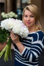 Young blonde woman in blue dress with peonies bouquet Royalty Free Stock Photo