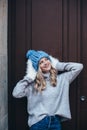 Blonde woman in blue knitted hat
