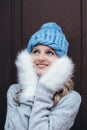 Blonde woman in blue knitted hat