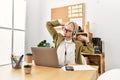 Young blonde woman business worker agent tired stretching back at office