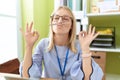 Young blonde woman business worker doing yoga exercise at office Royalty Free Stock Photo