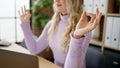 Young blonde woman business worker doing yoga exercise at office Royalty Free Stock Photo