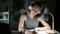 Young blonde woman business worker listening to music taking notes at the office Royalty Free Stock Photo