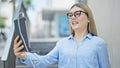 Young blonde woman business worker smiling confident having video call at street Royalty Free Stock Photo