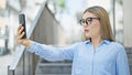 Young blonde woman business worker smiling confident having video call at street Royalty Free Stock Photo