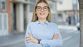 Young blonde woman business worker smiling confident standing with arms crossed gestur at street Royalty Free Stock Photo