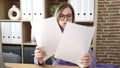 Young blonde woman business worker stressed reading document at office