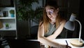 Young blonde woman business worker using laptop taking notes at the office Royalty Free Stock Photo