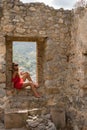 Young blonde woman contemplating the majestic view. Tourist in Sicily, Italy .