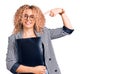 Young blonde woman with curly hair holding business folder pointing finger to one self smiling happy and proud Royalty Free Stock Photo