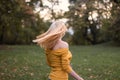 Young blonde woman dancing, turning around in the park Royalty Free Stock Photo