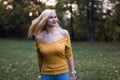 Young blonde woman dancing in the park, turning around Royalty Free Stock Photo