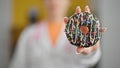 Young blonde woman dietician holding doughnut at clinic