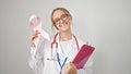 Young blonde woman doctor holding breast cancer awareness pink ribbon and clipboard over isolated white background Royalty Free Stock Photo