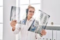 Young blonde woman doctor looking xray standing at clinic Royalty Free Stock Photo