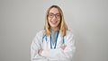 Young blonde woman doctor smiling confident standing with arms crossed gesture over isolated white background Royalty Free Stock Photo
