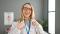 Young blonde woman doctor smiling confident wearing stethoscope at clinic Royalty Free Stock Photo