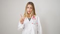 Young blonde woman doctor standing with serious expression saying no with finger over isolated white background Royalty Free Stock Photo
