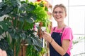 Young blonde woman florist using diffuser working smiling at flower shop Royalty Free Stock Photo