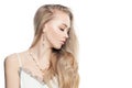 Young blonde woman with gold jewelry earrings and chain necklace isolated on white background, portrait Royalty Free Stock Photo