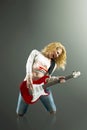 young blonde woman with a guitar sings a rock song