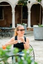 Young blonde woman having espresso coffee in outdoor cafe Royalty Free Stock Photo