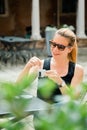 Young blonde woman having espresso coffee in outdoor cafe Royalty Free Stock Photo
