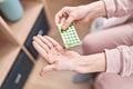 Young blonde woman holding birth control pills sitting on bed at bedroom Royalty Free Stock Photo