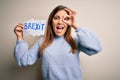 Young blonde woman holding brexit banner from political referendum over isolated background with happy face smiling doing ok sign Royalty Free Stock Photo