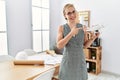 Young blonde woman holding drone at architect office smiling happy pointing with hand and finger Royalty Free Stock Photo