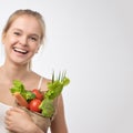 Young woman holding grocery paper shopping bag full of fresh vegetables. Diet healthy eating concept Royalty Free Stock Photo